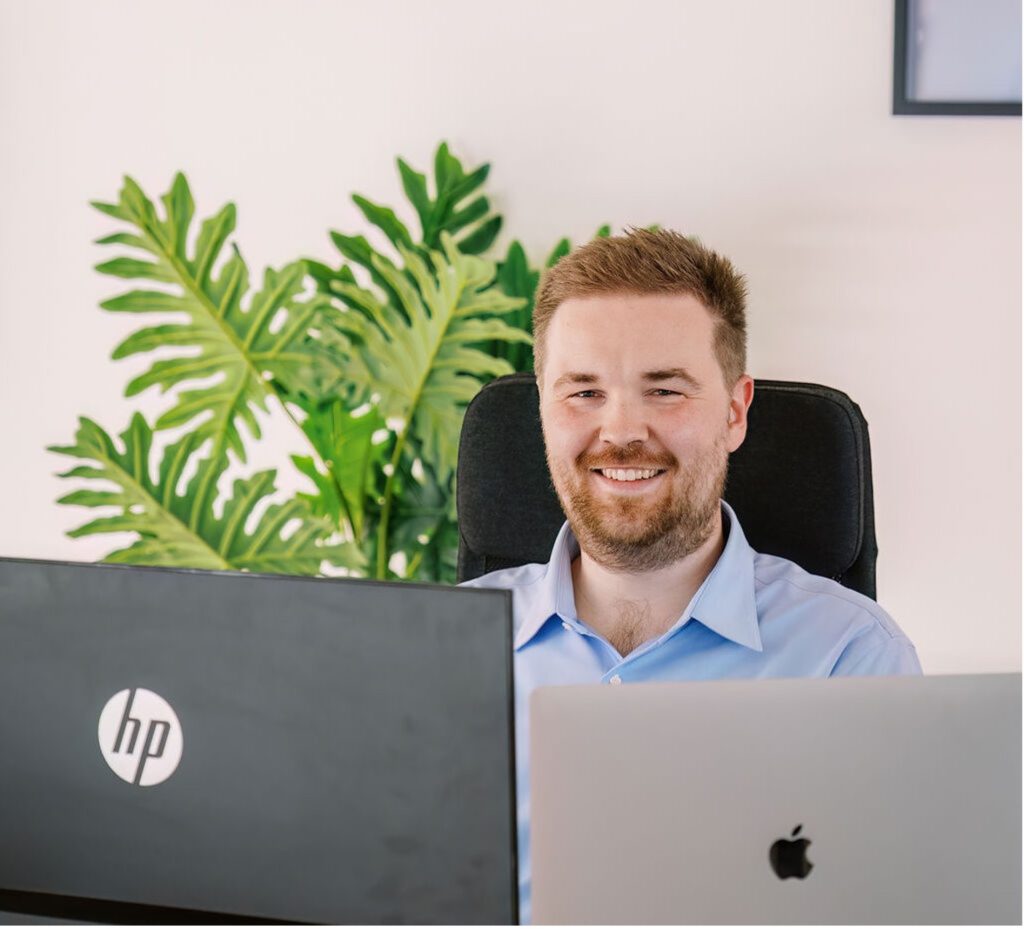 Ruben Wouters at desk in office with plant in background